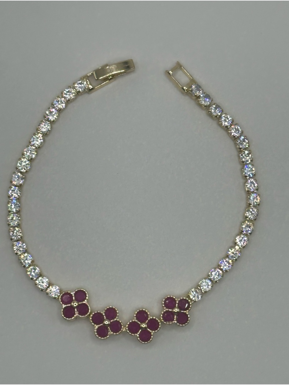 Gold Tone Tennis Bracelet with Ruby-Red Clovers